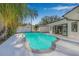 Enjoy a relaxing swim in this inviting pool, with sliding glass doors into the house at 4495 Clearwater Harbor S Dr, Largo, FL 33770