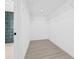 Spacious walk-in closet with ample shelving and modern wood-look floors at 4495 Clearwater Harbor S Dr, Largo, FL 33770