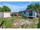 Large backyard featuring a deck, storage shed, and a covered patio area for entertaining at 5001 37Th N Ave, St Petersburg, FL 33710