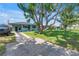 Charming home featuring a well-maintained front yard, driveway, and mature trees at 5001 37Th N Ave, St Petersburg, FL 33710