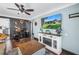 Inviting living room featuring a rustic fireplace and a dedicated workspace at 5001 37Th N Ave, St Petersburg, FL 33710