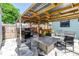 Covered patio area featuring a BBQ grill, bar seating, a dining table, and outdoor lighting at 5001 37Th N Ave, St Petersburg, FL 33710