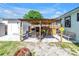 This outdoor patio features a BBQ grill, bar seating and a dining table, perfect for entertaining at 5001 37Th N Ave, St Petersburg, FL 33710