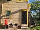 Backyard entry with metal door and stairs plus outdoor seating area at 516 7Th W Ave # 1, Palmetto, FL 34221