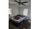 Cozy bedroom featuring natural light from two windows and a ceiling fan at 516 7Th W Ave # 1, Palmetto, FL 34221