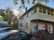 Multi-Gathering, two-story home with a front porch and multiple cars in the driveway at 516 7Th W Ave # 1, Palmetto, FL 34221