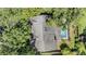 Aerial view of the house showing the roof and a screened in swimming pool at 5423 Windbrush Dr, Tampa, FL 33625