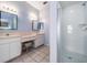 Bright and airy bathroom with a vanity, separate makeup counter, and a tile and glass shower at 5423 Windbrush Dr, Tampa, FL 33625