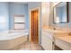 Bright bathroom featuring a tub under a window and a single sink vanity at 5423 Windbrush Dr, Tampa, FL 33625