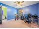 Blue bedroom with carpet, chair, desk, and window for natural light at 5423 Windbrush Dr, Tampa, FL 33625