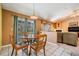 Dining area with pool view through sliding glass doors, adjacent to the living room at 5423 Windbrush Dr, Tampa, FL 33625