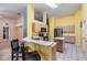 Open concept kitchen featuring a breakfast bar, modern stainless steel refrigerator, and tile flooring at 5423 Windbrush Dr, Tampa, FL 33625