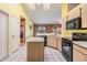 Bright eat-in kitchen with an island, black appliances, and tile flooring throughout at 5423 Windbrush Dr, Tampa, FL 33625