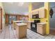Well-equipped kitchen with an island, stainless appliances, tile flooring, and a bright atmosphere at 5423 Windbrush Dr, Tampa, FL 33625