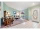 Comfortable living room featuring tile and carpet flooring, a large window, and neutral paint at 5423 Windbrush Dr, Tampa, FL 33625
