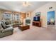 Spacious living room with plush seating, fireplace, neutral tones, and a ceiling fan at 5423 Windbrush Dr, Tampa, FL 33625