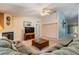 Comfortable living room with a ceiling fan, fireplace, and neutral walls, with lots of natural light at 5423 Windbrush Dr, Tampa, FL 33625
