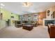 Large living room with a fireplace, plush seating, and seamlessly flowing into the dining area at 5423 Windbrush Dr, Tampa, FL 33625