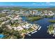Aerial view showcasing waterfront homes, boat docks, and lush landscaping within a vibrant coastal community setting at 5567 Sea Forest Dr # 323, New Port Richey, FL 34652