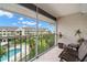 Enjoy views of the pool and lush landscape from this screened-in balcony with seating at 5567 Sea Forest Dr # 323, New Port Richey, FL 34652