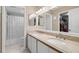 Bright bathroom featuring a double sink vanity, large mirror, and tiled floors at 5567 Sea Forest Dr # 323, New Port Richey, FL 34652