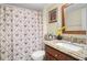 Bathroom featuring a granite countertop vanity and decorative palm tree shower curtain at 5567 Sea Forest Dr # 323, New Port Richey, FL 34652
