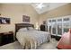 Comfortable bedroom with a vaulted ceiling, neutral paint, and a large window at 5567 Sea Forest Dr # 323, New Port Richey, FL 34652
