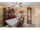 Traditional dining room with wooden furniture, a large china cabinet, and a view to the kitchen at 5567 Sea Forest Dr # 323, New Port Richey, FL 34652