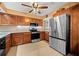 Well-lit kitchen features wooden cabinetry, stainless steel appliances, and neutral countertops at 5567 Sea Forest Dr # 323, New Port Richey, FL 34652