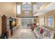Bright living room featuring high ceilings, wood floors, and modern decor at 5567 Sea Forest Dr # 323, New Port Richey, FL 34652