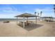 Picturesque beachfront picnic area with shaded tables, perfect for enjoying outdoor meals and beach views in this community at 5567 Sea Forest Dr # 323, New Port Richey, FL 34652