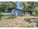 View of the backyard showcasing the house, screened porch and new fence at 6 Harbor Cove St, Safety Harbor, FL 34695