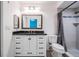 Modern bathroom featuring a white vanity with dark hardware and a tiled shower with a glass door at 6 Harbor Cove St, Safety Harbor, FL 34695