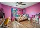 A bedroom with colorful walls, a ceiling fan, hardwood flooring, and a window at 6 Harbor Cove St, Safety Harbor, FL 34695