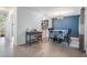 Open-concept dining room adjacent to the kitchen, featuring tile floors and a blue accent wall at 6 Harbor Cove St, Safety Harbor, FL 34695