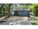 Beautifully maintained home showcasing the front exterior, mature trees, and manicured landscaping at 6 Harbor Cove St, Safety Harbor, FL 34695