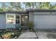 Charming home with a bay window, gray door, and landscaped walkway leading to the entrance at 6 Harbor Cove St, Safety Harbor, FL 34695
