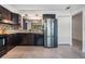 Bright kitchen with stainless steel refrigerator, granite counters, mosaic backsplash, and tile floors at 6 Harbor Cove St, Safety Harbor, FL 34695
