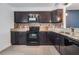 Features dark brown cabinets with granite countertops and stainless steel appliances at 6 Harbor Cove St, Safety Harbor, FL 34695