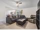Bright living room featuring tile floors, a comfortable sectional sofa, and a large window at 6 Harbor Cove St, Safety Harbor, FL 34695