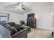 Spacious living room with tile floors, a comfortable gray sofa, and natural light at 6 Harbor Cove St, Safety Harbor, FL 34695