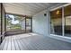 Inviting screened porch featuring wood flooring and a sliding glass door access to indoors at 6 Harbor Cove St, Safety Harbor, FL 34695