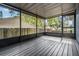 Spacious screened porch with a wood floor, ideal for outdoor relaxation and entertaining at 6 Harbor Cove St, Safety Harbor, FL 34695