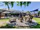 Landscaped backyard with fire pit and play area visible from the screened pool at 604 Knollwood Dr, Largo, FL 33770