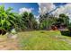 Expansive backyard with a grassy area, a small garden, and plenty of space for outdoor activities at 604 Knollwood Dr, Largo, FL 33770