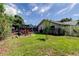Well-maintained backyard with a play area, lush lawn, and an enclosed patio, great for relaxation at 604 Knollwood Dr, Largo, FL 33770