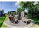Backyard fire pit area with rustic seating, offering a relaxing outdoor space at 604 Knollwood Dr, Largo, FL 33770