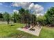 Grassy backyard featuring an outdoor workout area with a weight rack at 604 Knollwood Dr, Largo, FL 33770