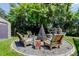 Inviting backyard fire pit area with unique seating, ideal for outdoor gatherings at 604 Knollwood Dr, Largo, FL 33770