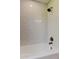 Bathroom featuring a bathtub with white subway tile and a shower head at 604 Knollwood Dr, Largo, FL 33770